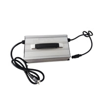 A silver and black 15A charger with a built-in handle and a fan, featuring a voltmeter display and attached black cables.