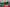 Close-up of motorcycle handlebar with throttle and grips on a blurred background